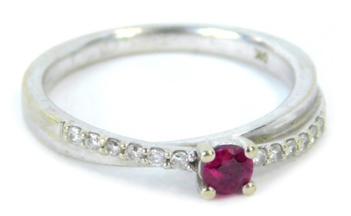 A 9ct white gold dress ring, of twist design, set with tiny diamonds and central garnet, ring size M, 2.3g all in.