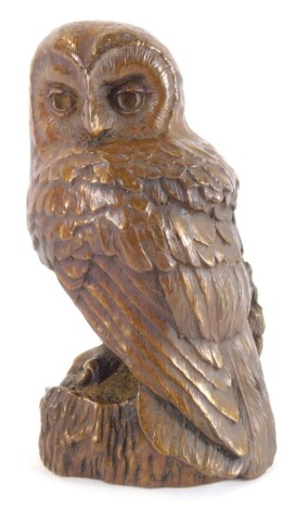 A 20thC Ken Norris bronzed metal figure of an owl, modelled standing on a naturalistic ground, bears label, 13cm high.