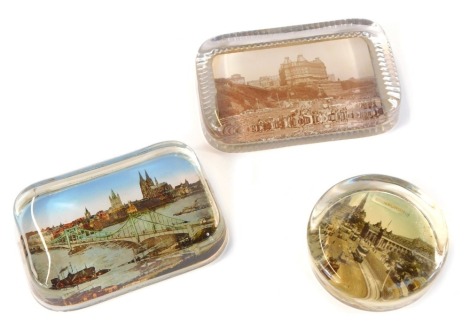 Three Victorian glass and photographic paperweights, showing views of Scarborough, Edinburgh, and Koln.