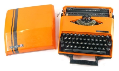 A Smith-Corona orange cased typewriter, designed by Ghia, with an orange and black striped lid.