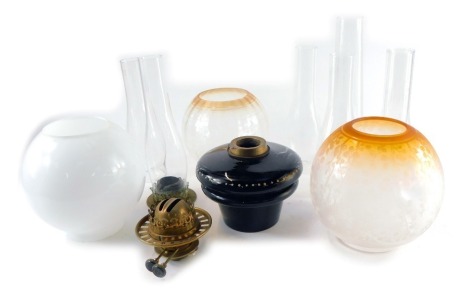 Victorian and later oil lamp parts, including shades, chimneys, and a brown pottery reservoir. (a quantity)