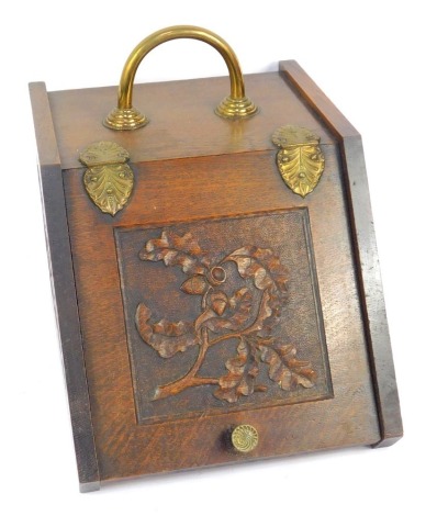 A Victorian oak coal box, with brass handle, hinges, and knob, carved to the front panel with acorns and oak leaves, with lead liner, 23cm wide.