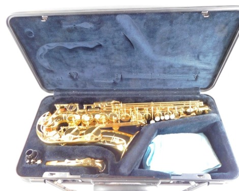 A Yamaha brass saxophone, Yas-275, number 257424, cased, together with stands, music books and cleaning implements.