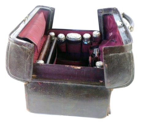 A Victorian Asprey lady's fitted red Morocco travelling case, the catched double hinged top opening to reveal a red watered silk interior containing a travelling inkwell, card case, pin case, vesta case, folding strut mirror, stationary pouch, together w