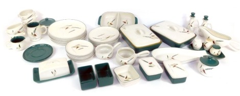 A Denby Green Wheat pattern part dinner service, comprising two rectangular tureens and covers, oven ware dish, butter dish, two preserve jars, ramekins, fish server, olive oil and vinaigrette bottles, gravy boat, eight dinner plates, five medium plates, 