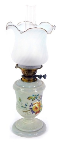 A Victorian grey glass oil lamp, painted with finches and roses, with chimney, and spiral fluted frosted glass shade, 57cm high.