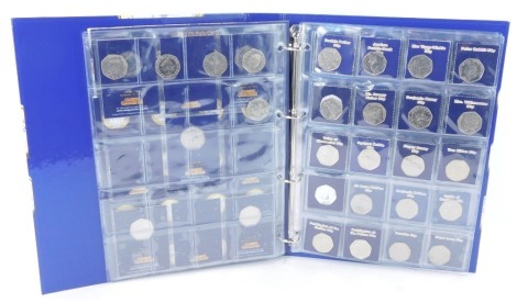 A collection of two pound and fifty pence coins, including London Underground, Great Fire of London, Darwin, and Brunel two pound coins, Kew Gardens, Beatrix Potter, Paddington, Benjamin Britten, and other fifty pence coins, in a Change Checker lever arch