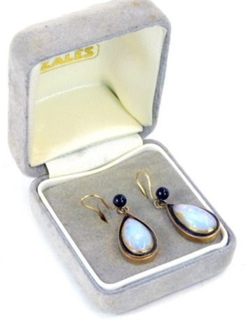 A pair of Moonstone and black enamel drop earrings, each formed as a tear drop, yellow metal backs, unmarked, 4.9g all in.