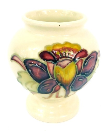 A Moorcroft Columbine pattern vase, impressed and painted marks, on a cream ground, with red and yellow peony, 9.5cm high.