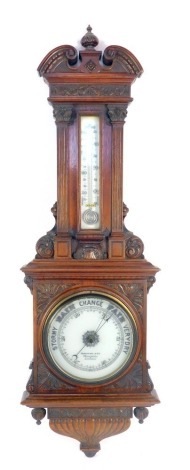 A Victorian Benetfink and Co of Cheapside London mahogany cased barometer, with heavily carved case and a mercury spiral dial, on a glass plain base, 100cm high.