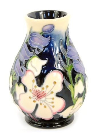 A Moorcroft Pottery vase decorated with flowers, 9.5cm high, boxed.