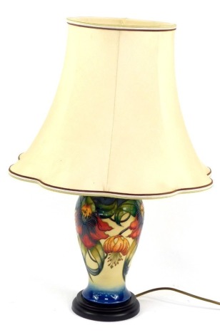 A Moorcroft Pottery lamp decorated in the Anna Lily pattern, with shade, 60cm high.