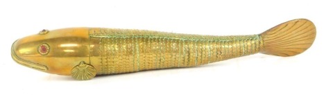 An articulated brass Medina style fish, with cabochon red set eyes, 26cm long.