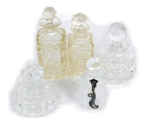 Five Victorian and later cut glass scent bottles, to include one of squat form, four rectangular, each with faceted stopper, the tallest 16cm high.