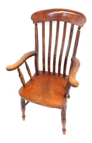 A Victorian elm and mahogany lath back kitchen chair, with solid saddle seat, raised on turned legs, united by a double H frame stretcher.