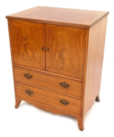 An Edwardian flame mahogany side cabinet, with a two cupboard top above an arrangement of two drawers, with metal swing handles on out splayed legs, 82cm high, 63cm wide, 47cm deep.