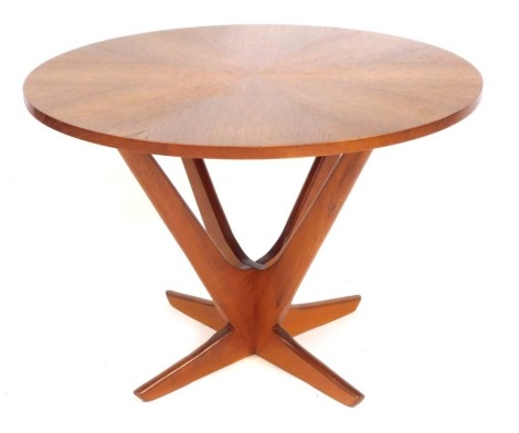 A Soren Georg Jensen Kubus radial teak Danish coffee table, with a sectional circular top, raised on intersecting V shaped supports, 54cm high, 77cm diameter.