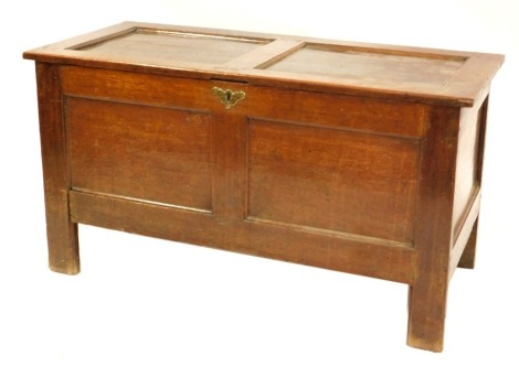 An 18thC oak coffer, with a double paneled top and front, raised on stile supports, 61cm high, 112cm wide, 49cm deep.