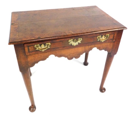 A George II oak and burr walnut cross banded side table, with single drawer with brass escutcheon and swing handles, on pad feet, 74cm high, 79cm wide, 50cm deep. (AF)