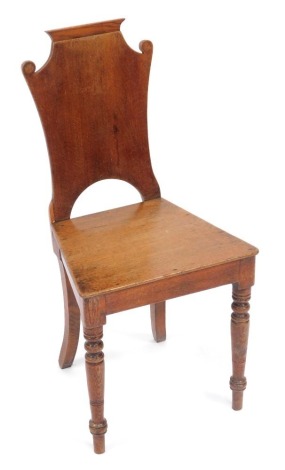 A Victorian oak hall chair, with a shaped shield back, 90cm high.