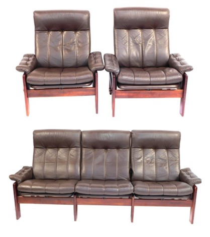 A Skipper Mobler Danish sofa suite, comprising three seater reclining sofa and two matching armchairs, each with teak frame and brown leather cushions, 200cm wide, 90cm high, 67cm deep, the chair 80cm wide, 90cm high, 67cm deep.