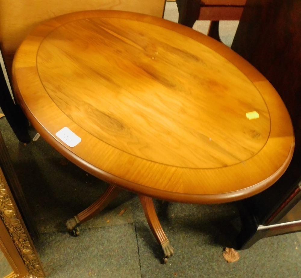 A style yew wood oval coffee table.