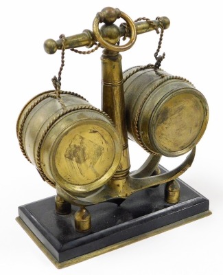 A 19thC brass nautical related combination clock and barometer, modelled in the form of a ship's anchor and two barrels, the enamel clock dial bearing Roman numerals and a subsidiary seconds dial, key wind, the centre with a mercury filled thermometer, ra - 6