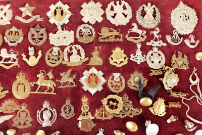 A quantity of various cap badges, early 20thC, to include Quis Separabit, 5cm high, various other regiments, Army Service, Royal Corps De Signals, various other, on a velvet frame backing, with various buttons, badges, stick pins, etc. (a quantity) - 3