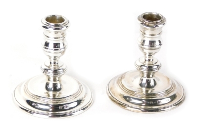 A pair of Elizabeth II squat candlesticks, by Mappin and Webb, each on stepped circular bases, London 1974, 10cm high, 14.5oz all in. (2 weighted)