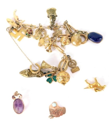 A slender link charm bracelet, marked .375, and a quantity of various charms, some set with stones, to include bagpipes, 0.5cm high, etc., a single amethyst set ear stud, loose Australia charm marked 9ct, set with opal, dog charm, etc., mainly 9ct gold, t