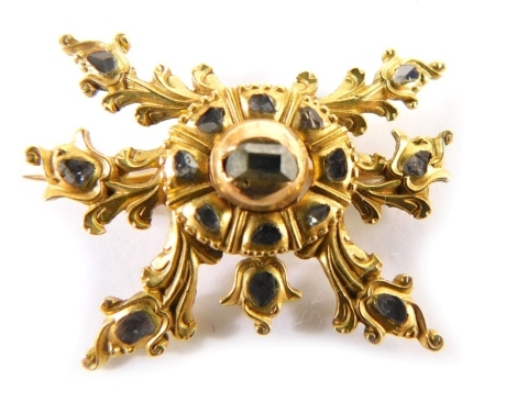 A Victorian brooch, of star design, set with diamond chips, on a single pin back with memorial panel, yellow metal unmarked, believed to be 18ct gold, 2.5cm wide, 3.5g all in.