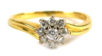 An 18ct gold diamond cluster ring, set with an arrangement of nine round brilliant cut stones, the central stone approx 0.10ct, the outer stones approx 0.06ct, each in claw setting, on twist design band, ring size Q½, 4.2g all in, boxed.