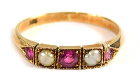 An Edwardian ruby and seed pearl dress ring, set with three rubies and two seed pearls, each in a box setting, on a rose gold band stamped 585, ring size M, 2g all in.