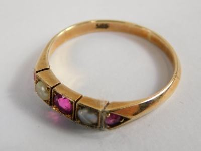 An Edwardian ruby and seed pearl dress ring, set with three rubies and two seed pearls, each in a box setting, on a rose gold band stamped 585, ring size M, 2g all in. - 2