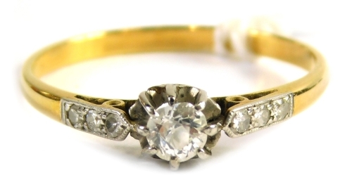 An 18ct gold diamond solitaire ring, set with central old cut diamond approx 0.15ct, in a platinum claw setting with tiny diamond set shoulders, on a yellow metal band, unmarked, ring size P½, 1.g all in.