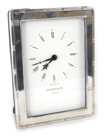 An Elizabeth II silver framed table clock, by Kitney and Co London, with stencilled 9cm wide back plate and easel back.