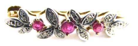 A 9ct gold brooch, claw set with pink stones, with an arrangement of leaves set with small white stones, 3cm long, 1.3g all in.