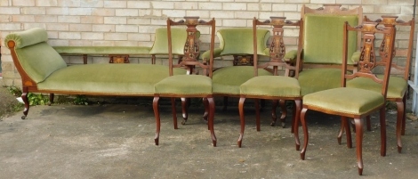 An Edwardian mahogany and marquetry salon suite, comprising settee with padded back, on cabriole legs, a tub type chair, an open armchair, and four salon chairs, each with a pierced vase shaped splat, padded seat on cabriole legs.