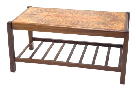 A 1970s G-Plan style teak coffee table, with a pattern tile top and a slatted undertier, 87cm wide.