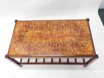 A 1970s G-Plan style teak coffee table, with a pattern tile top and a slatted undertier, 87cm wide. - 2