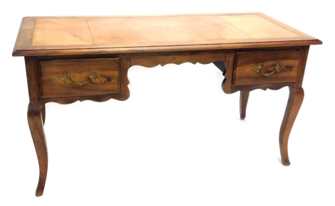 A French walnut writing table, the rectangular top with a brown tooled leather inset, above two frieze drawers, on cabriole legs, 78cm high, 150cm wide.