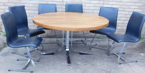 An Indian rosewood circular dining table, by Robert Young for Merrow Associates, on a chrome plated base with splayed feet, and six chairs each upholstered in black leatherette, on chrome support, the top 137cm diameter.