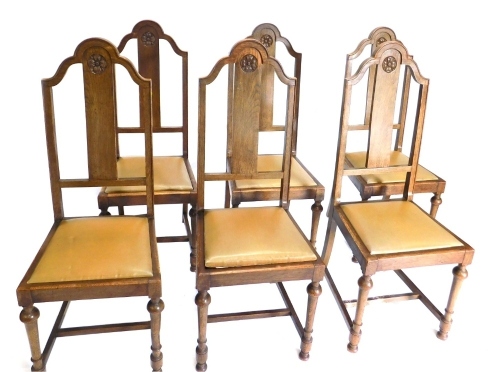 A set of 6 oak high back dining chairs, each with Tudor rose splats, with drop in seats on turned front legs, 118cm high.