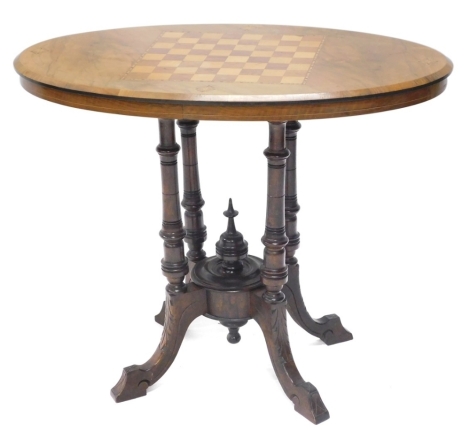 A Victorian walnut and marquetry loo table, the oval top with a moulded edge, on four turned supports and leaf carved cabriole legs, 70cm high, 82cm wide.