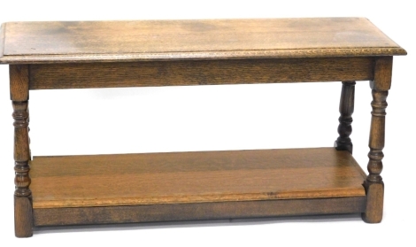 An oak magazine rack, in the manner of Titchmarsh and Goodwin, with rectangular table top, 49cm wide, an oak coffee table, and an oak occasional table. (3)