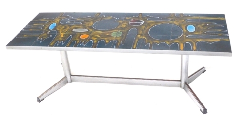 A 1960s/70s polished metal coffee table, the rectangular top inset with a psychedelic abstract in coloured tiles, on turned supports with splayed base, Abri Belgique, 41cm high, 123cm wide.