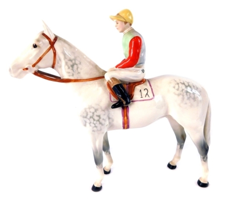 A Beswick pottery horse and jockey, with number 12 saddling cloth, printed marks beneath, 18cm high.