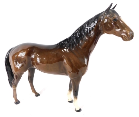 A large Beswick pottery bay horse, with front white legs, printed marks beneath, 25cm high.