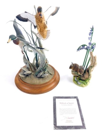 A Franklin Mint Ducks Unlimited Mallards at Sunset matt finish figure, on wooden plinth base, marked beneath, 27cm high, and a Teviotdale field mouse group. (2)