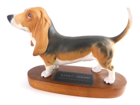 A Beswick Connoisseur matt pottery figure of a basset hound, on wooden plinth base, 17cm high.